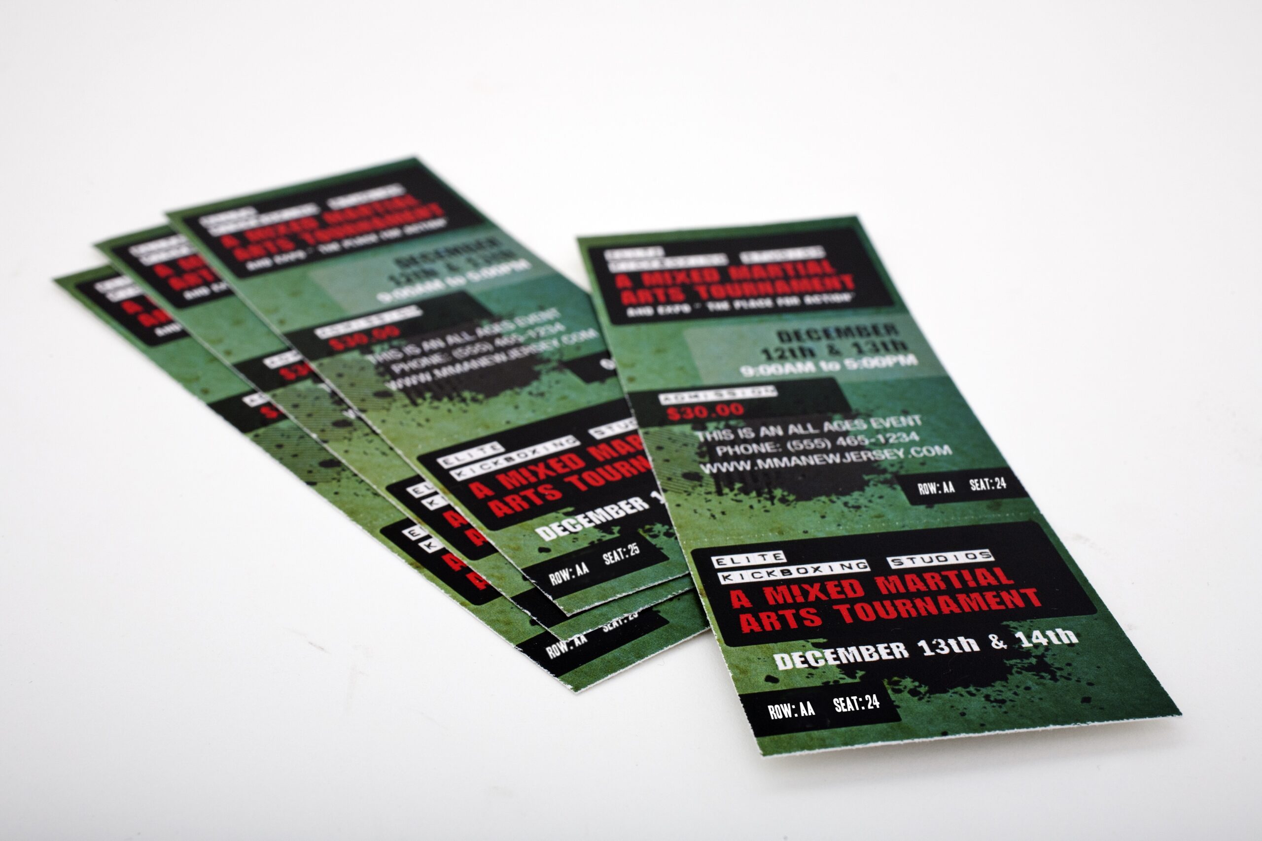 Stack of printed MMA event tickets featuring reserved seating information