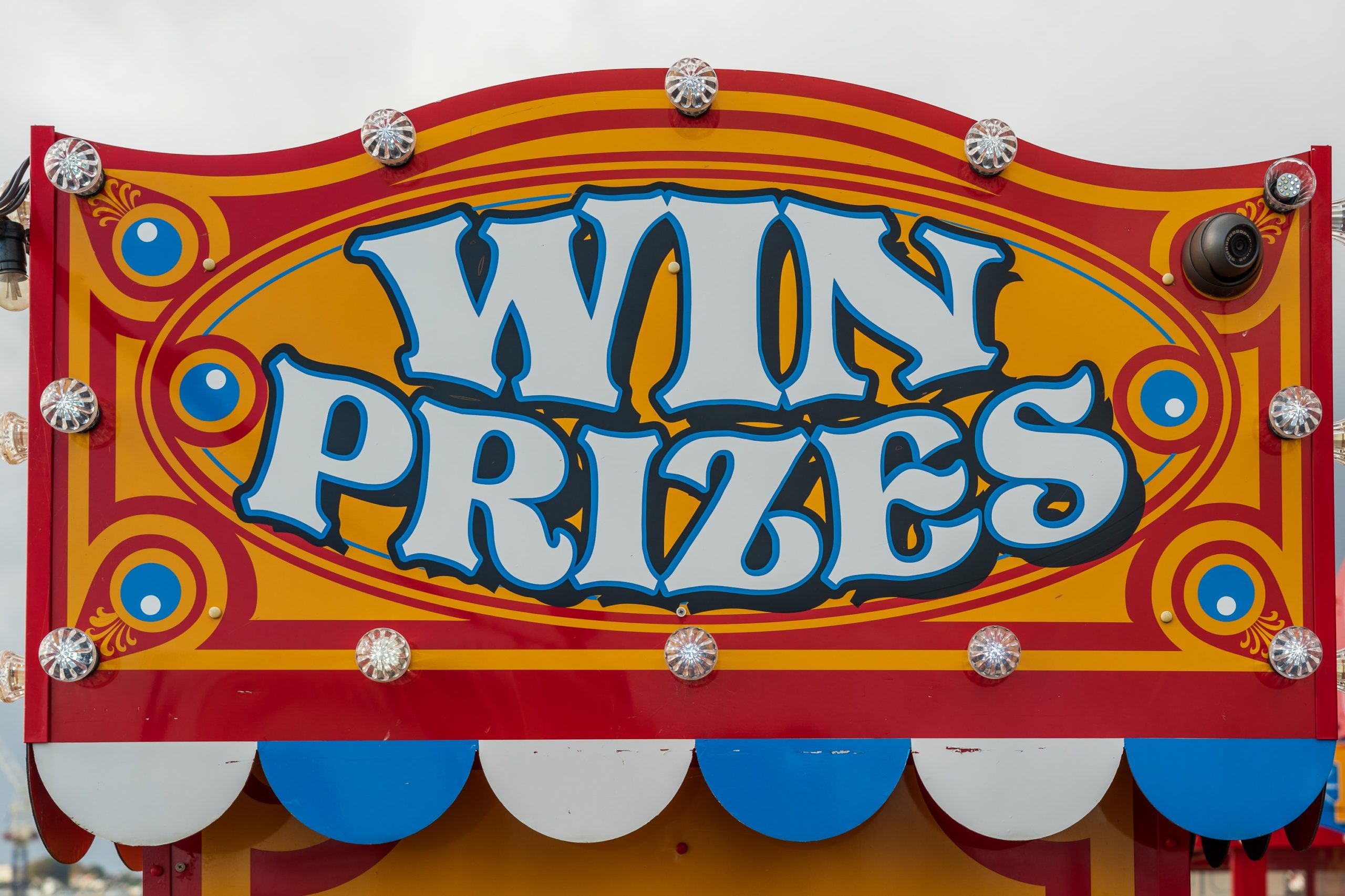 a a brightly colored carnival game whose sign reads 'win prizes"