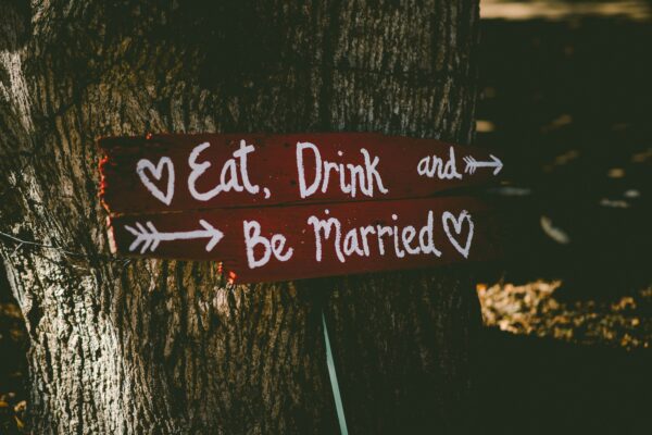 a wedding sign reading eat, drink + be married
