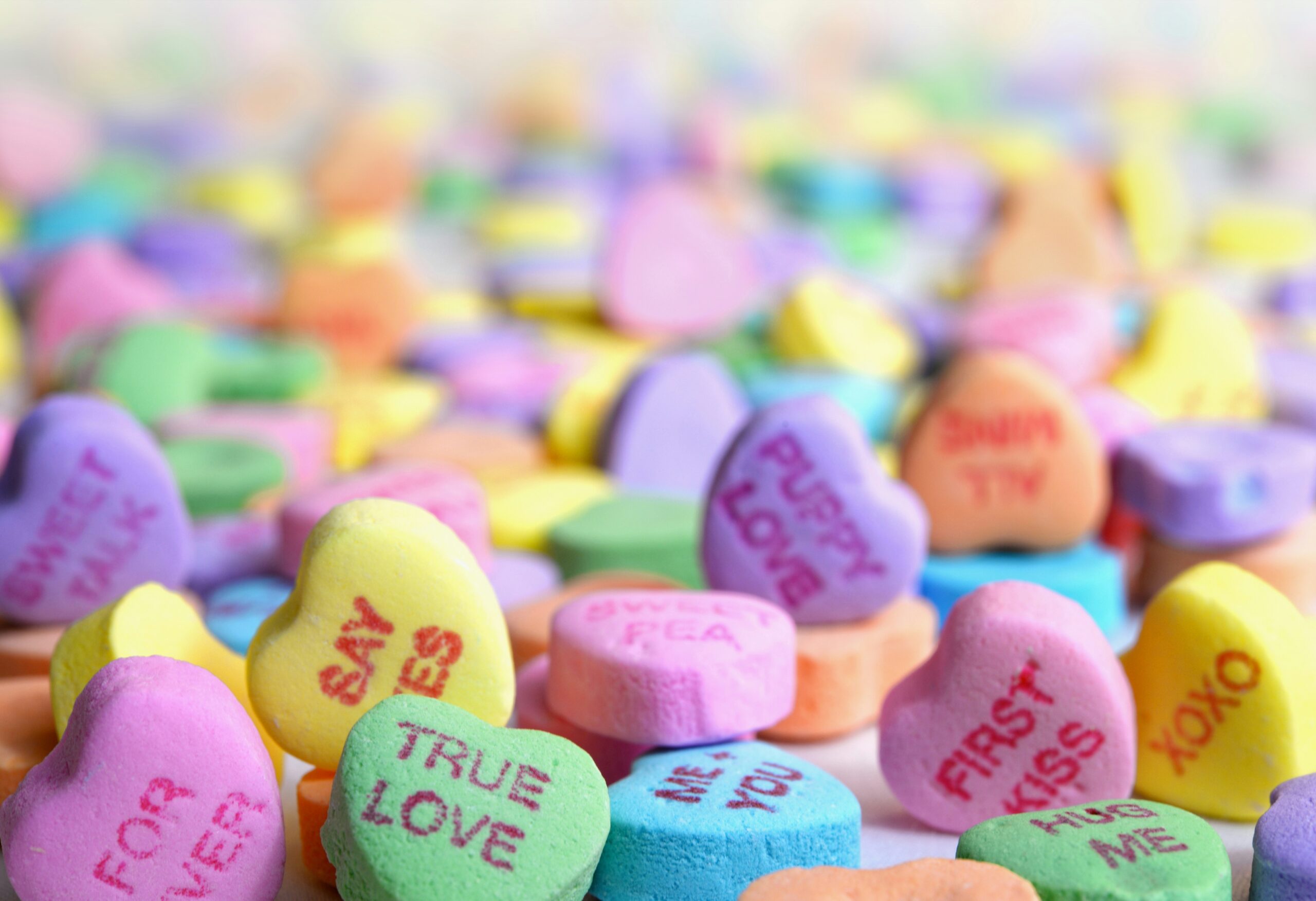 a pile of colorful conversation heart candies