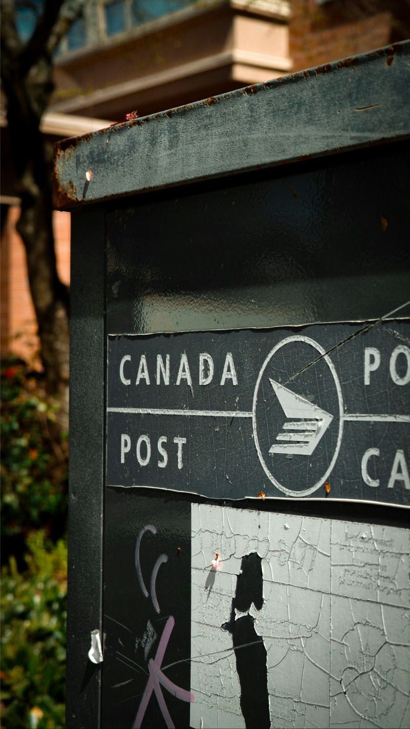 canada-post-mailbox-toronto-street-2 Weathered Canada Post mailbox on a Toronto street, showing signs of wear and urban graffiti